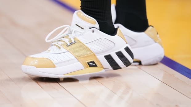 White, gold, and black Adidas shoes.